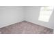Bedroom featuring neutral carpet, white trim, and natural light at 144 Ashworth Dr., Tabor City, NC 28463