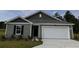 Charming single-Gathering home with a two-car garage and professionally landscaped yard at 144 Ashworth Dr., Tabor City, NC 28463