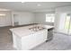 Stylish kitchen island with double sink, stainless steel dishwasher, and view into living spaces at 144 Ashworth Dr., Tabor City, NC 28463