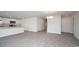 Open-concept living room and kitchen with light gray floors and white cabinets at 144 Ashworth Dr., Tabor City, NC 28463