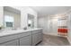 Bright bathroom featuring double sink vanity, tile floor, and a shower with colorful curtain at 147 Ashworth Dr., Tabor City, NC 28463