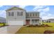 Charming two-story home with a two-car garage, lovely landscaping, and a cozy front porch at 147 Ashworth Dr., Tabor City, NC 28463