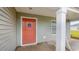 Close-up of the front door with a peach finish and a covered porch with white support beams at 147 Ashworth Dr., Tabor City, NC 28463