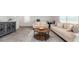 Bright living room showcasing a cozy seating arrangement and stylish round wood coffee table at 147 Ashworth Dr., Tabor City, NC 28463