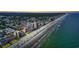 Picturesque aerial view of oceanfront condos along a pristine beach, offering a vibrant coastal lifestyle at 1690 N Waccamaw Dr. # 1008, Garden City Beach, SC 29576