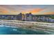 Beautiful aerial view of oceanfront condos on a sandy beach with clear blue water, creating a perfect vacation destination at 1690 N Waccamaw Dr. # 1008, Garden City Beach, SC 29576