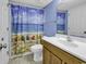 Bright bathroom with ocean themed shower curtain and updated fixtures at 1690 N Waccamaw Dr. # 1008, Garden City Beach, SC 29576