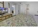 Relaxing bedroom leading into the bathroom with neutral colors and tv at 1690 N Waccamaw Dr. # 1008, Garden City Beach, SC 29576