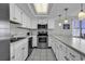 Kitchen featuring white cabinetry, stainless steel appliances, and updated countertops at 1690 N Waccamaw Dr. # 1008, Garden City Beach, SC 29576