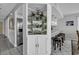 Stylish kitchenette featuring a mirrored display case, bar stool seating, and modern design elements at 1690 N Waccamaw Dr. # 1008, Garden City Beach, SC 29576