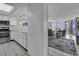 Bright living space featuring ocean views, tile floors, and a seamless flow from the kitchen to the balcony at 1690 N Waccamaw Dr. # 1008, Garden City Beach, SC 29576