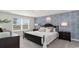 Tranquil bedroom with patterned wallpaper, ample natural light and black frame bed with stylish pillows at 164 Ashworth Dr., Tabor City, NC 28463