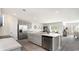 Spacious kitchen with stainless steel appliances, an island, and an open view of the dining and living areas at 164 Ashworth Dr., Tabor City, NC 28463