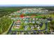Expansive aerial view showcasing a neighborhood with homes, a lake, and recreational facilities at 176 Somerworth Circle, Surfside Beach, SC 29575