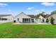Beautifully landscaped backyard featuring a pool, patio, and well-manicured lawn at 176 Somerworth Circle, Surfside Beach, SC 29575