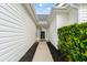 Covered entryway featuring a decorative glass front door and lush, green shrubs at 176 Somerworth Circle, Surfside Beach, SC 29575