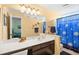 Bright bathroom featuring a single sink vanity, decorative fish accents, and a blue sun and moon shower curtain at 1950 Bent Grass Dr. # K, Surfside Beach, SC 29575