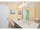 Well-lit bathroom with a large mirror, single sink vanity, and view into a walk-in closet for added convenience at 1950 Bent Grass Dr. # K, Surfside Beach, SC 29575