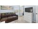 Bright bedroom featuring a sofa, dresser with television, and large window providing ample natural light at 1950 Bent Grass Dr. # K, Surfside Beach, SC 29575