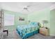 The light green bedroom has a ceiling fan, queen bed, side tables, and a view to the backyard at 1950 Bent Grass Dr. # K, Surfside Beach, SC 29575