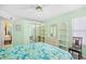 The light green bedroom is features a queen bed, sliding door closet, and view to another room at 1950 Bent Grass Dr. # K, Surfside Beach, SC 29575