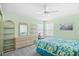 The bedroom is painted in a light green and features a queen bed and wicker furniture at 1950 Bent Grass Dr. # K, Surfside Beach, SC 29575