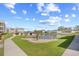 Serene view of a pond, lawn, and condo building in a well-maintained community at 1950 Bent Grass Dr. # K, Surfside Beach, SC 29575