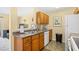 This bright kitchen offers a stainless steel sink, wood cabinets, and modern appliances at 1950 Bent Grass Dr. # K, Surfside Beach, SC 29575