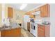 This kitchen has wood cabinets, white appliances, granite countertops, and a double stainless steel sink at 1950 Bent Grass Dr. # K, Surfside Beach, SC 29575