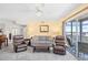 Inviting living room with carpet, contemporary furnishings, and a sliding glass door to balcony at 1950 Bent Grass Dr. # K, Surfside Beach, SC 29575
