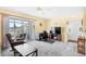 Bright living area features a desk, tv, and access to the screened in balcony at 1950 Bent Grass Dr. # K, Surfside Beach, SC 29575