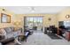 Welcoming living room with gray sofa, leather chairs, and a private balcony overlooking a waterway at 1950 Bent Grass Dr. # K, Surfside Beach, SC 29575