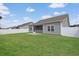 Backyard features a well maintained lawn, vinyl privacy fence, and rear view of the house at 200 Palm Terrace Loop, Conway, SC 29526