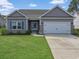 Charming single-story home featuring a two-car garage, landscaped lawn, and a welcoming entrance at 200 Palm Terrace Loop, Conway, SC 29526