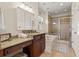 Elegant bathroom featuring granite counters, vanity with makeup area, jacuzzi tub, and tiled glass shower at 2039 Woodburn Dr., Myrtle Beach, SC 29579