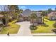 Charming brick home with a spacious driveway and beautiful landscaping, including mature trees and manicured lawn at 2039 Woodburn Dr., Myrtle Beach, SC 29579