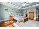 Bright main bedroom with tray ceiling, wood floors, large windows, ceiling fan, and stylish furnishings at 2039 Woodburn Dr., Myrtle Beach, SC 29579