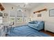 Bright home office space with large windows, a blue sofa, and hardwood floors at 2039 Woodburn Dr., Myrtle Beach, SC 29579