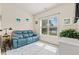 Cozy sitting area with a comfortable blue couch, natural light, and serene views overlooking the water at 2039 Woodburn Dr., Myrtle Beach, SC 29579