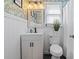 Stylish bathroom with unique wallpaper, a wooden-framed mirror, and modern fixtures at 205 Lander Dr., Conway, SC 29526