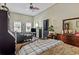 Bedroom with a ceiling fan, tv, wood-paneled dresser, and two windows providing natural light at 205 Lander Dr., Conway, SC 29526