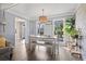 Bright dining room with a wooden table, a pendant light, and large windows offering views of the outdoors at 205 Lander Dr., Conway, SC 29526