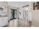 Hallway with black french doors to the backyard, and a view to the dining room with Say Grace sign at 205 Lander Dr., Conway, SC 29526