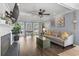 Bright living room with bay windows, a gray sofa, hardwood floors, and a fireplace at 205 Lander Dr., Conway, SC 29526