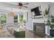 Cozy living room with a fireplace, ceiling fan, hardwood floors, and an abundance of natural light at 205 Lander Dr., Conway, SC 29526