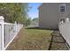 Fenced backyard featuring a well-maintained lawn and mature trees, offering privacy and outdoor enjoyment at 211 Oak Landing Dr., Conway, SC 29527