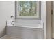 Close up of a white bathtub with a window above it for natural light at 211 Oak Landing Dr., Conway, SC 29527