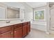 Bright bathroom with a double vanity, soaking tub, and a separate shower at 211 Oak Landing Dr., Conway, SC 29527