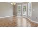 Bright dining area with light hardwood floors and large windows overlooking the backyard at 211 Oak Landing Dr., Conway, SC 29527