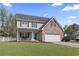 Attractive two-story home boasts a brick front, manicured lawn and a two-car garage at 211 Oak Landing Dr., Conway, SC 29527